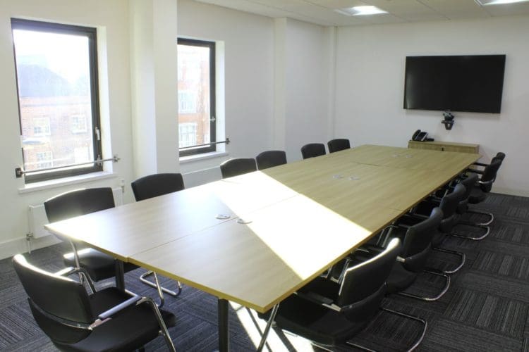 Meeting room with a conference table and TV installed for the CCW commercial fit out