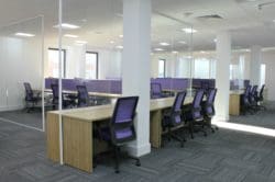 office space with glass partitions and a purple colour scheme