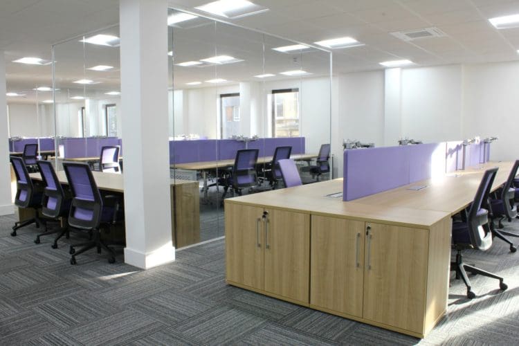 open plan office with glass partitions conceived by interior designers from london