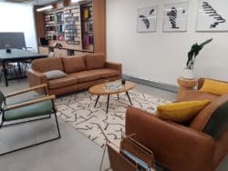 Modern workspace interior design with residential elements and comfortable furniture