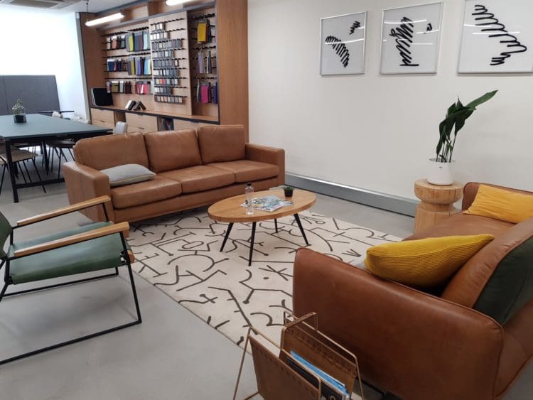 Modern workspace interior design with residential elements and comfortable furniture