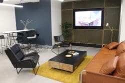 An office breakout area design with a coffee table and chairs