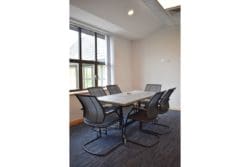 Office boardroom design with mesh back chairs and desk