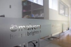Company logo glass manifestation at Language in Action in Brighton