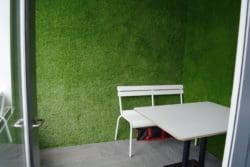an-office-meeting-room-with-imitation-grass-walls-and-furniture