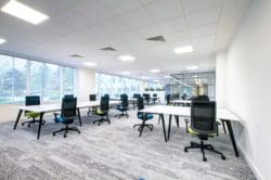 commercial interior design with shared desks and mesh back chairs