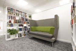 Client office waiting area with book shelves and acoustic furniture