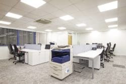 Office IT department with shared desks and a photocopier