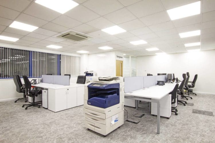 Office IT department with shared desks and a photocopier