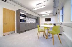 Office-breakout-area-design-with-dining-tables-and-a-tea-point