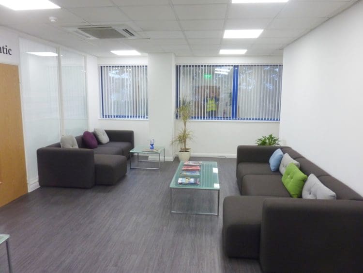 Office breakout area with modular sofas and glass coffee tables