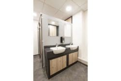 Office toilet sink area refurbishment with classic wooden panels and white basins