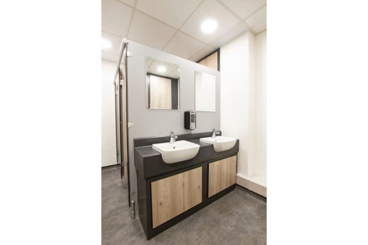 Office toilet sink area refurbishment with classic wooden panels and white basins