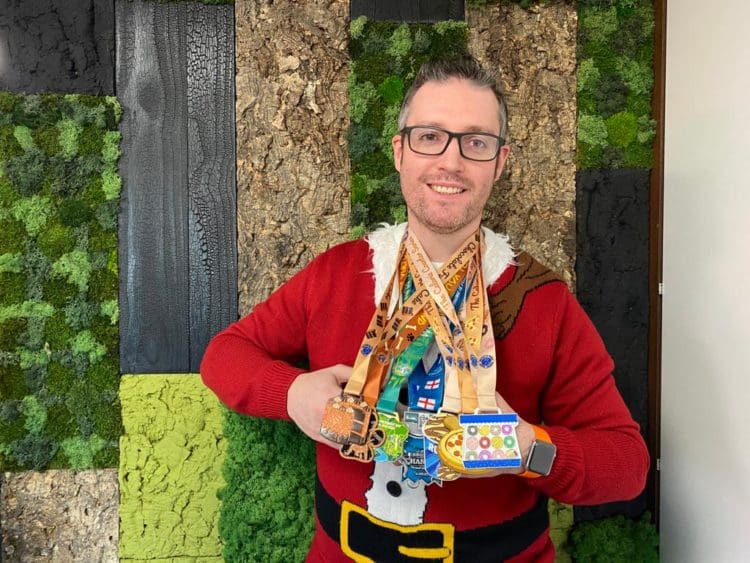 Interior designer Scott proudly showing his 5k running medals to support his mental health during the pandemic