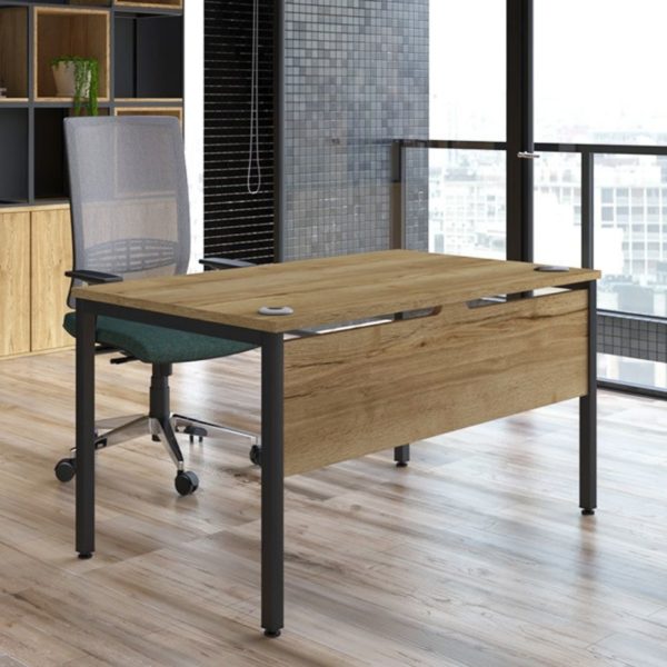 Wood finish office desk with kind mesh back task chair in an office environment with an industrial interior design