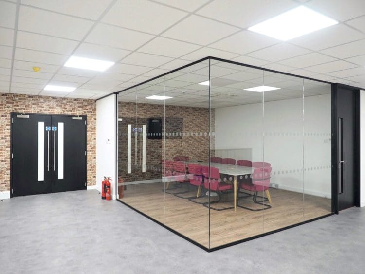 A large corner office meeting room with aluminium glass frame partitions