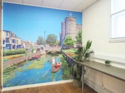 A colourful wall mural of Canterbury river in a Kent office kitchen area to create a calming breakout space for staff