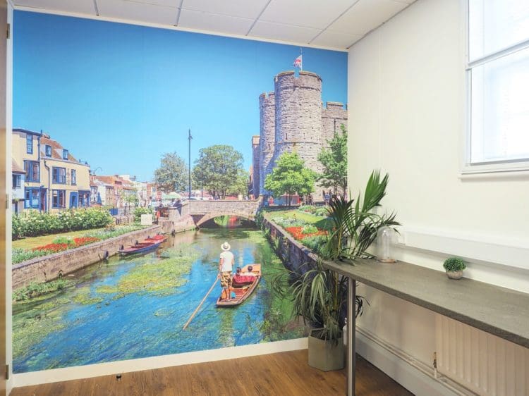A colourful wall mural of Canterbury river in a Kent office kitchen area to create a calming breakout space for staff