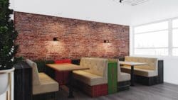 A red brick pattern effect wall mural against booths and tables in an office canteen
