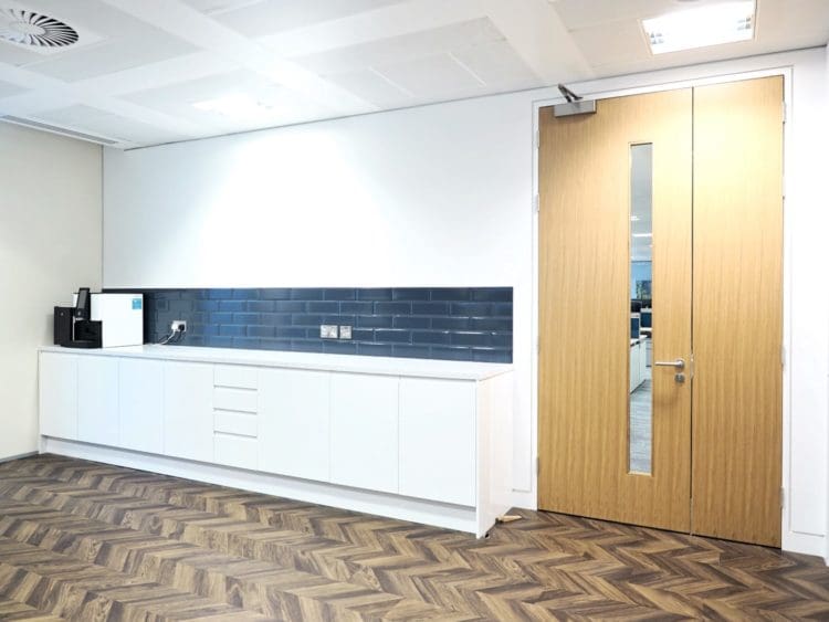 An office partition and tea point with a coffee machine and storage