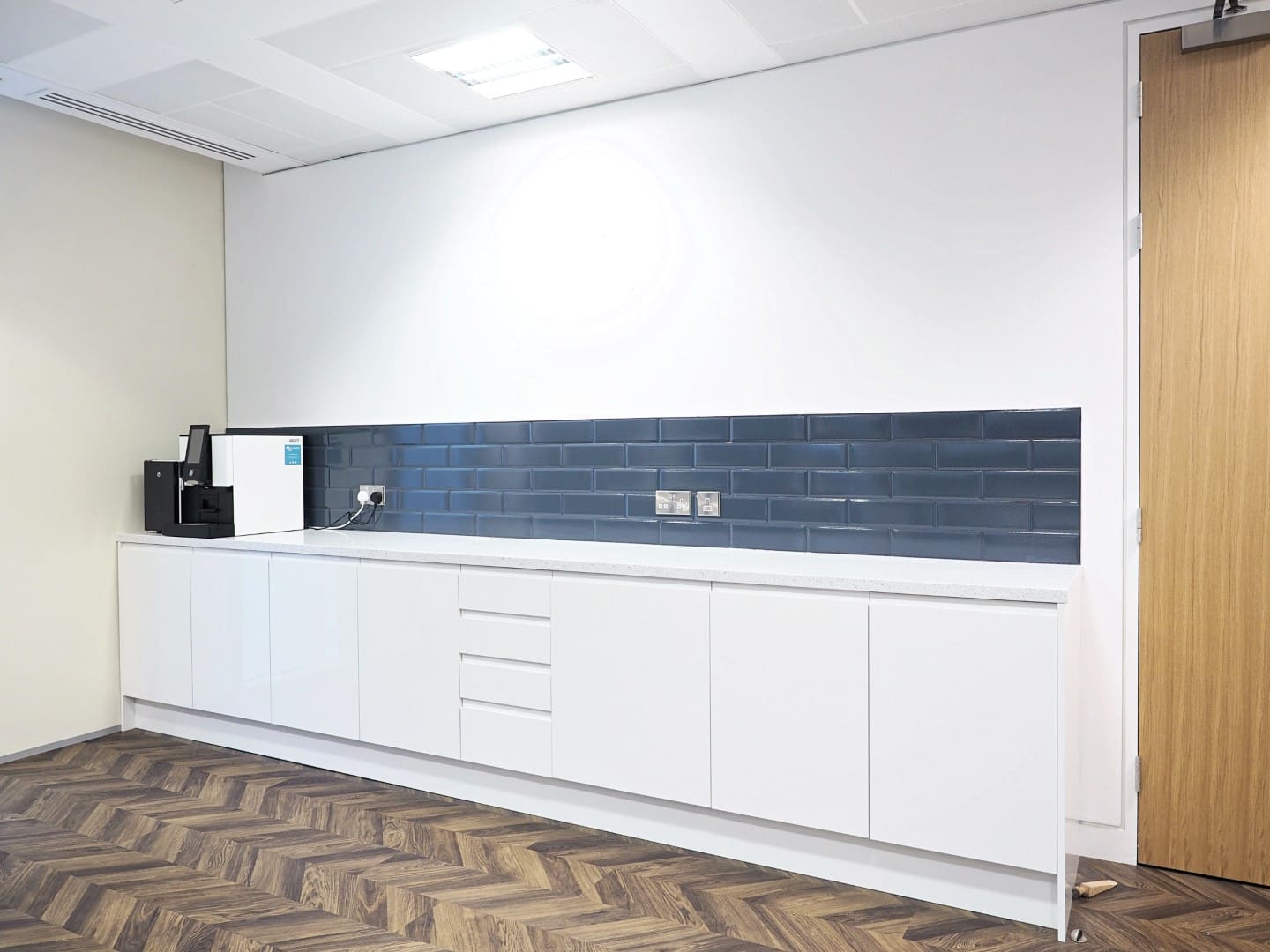 An office tea point with new tiles and modern cabinetry