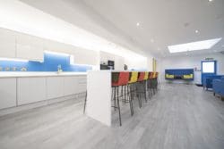 School staffroom kitchen with a poseur table and stools