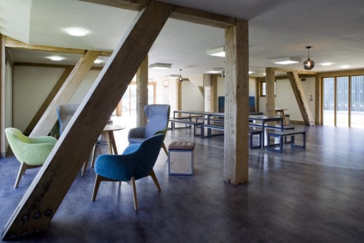 Sustainable workspace design with wooden beams and breakout furniture