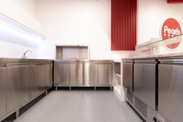 Commercial food and drink preparation area with stainless steel storage units
