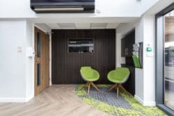 Sustainable office waiting area interior design with a slat wall and tv