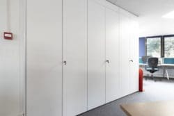 White ceiling height office storage wall at RSPB in Brighton