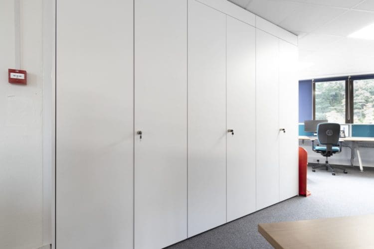 White ceiling height office storage wall at RSPB in Brighton