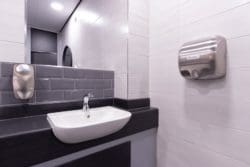 Newly installed school toilet hand dryer and sink