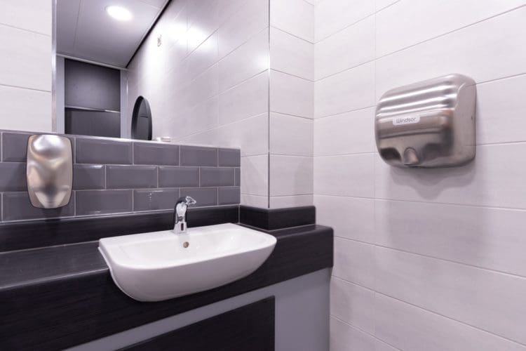 Newly installed school toilet hand dryer and sink