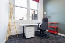 Office with modern coat stand and newly laid carpet