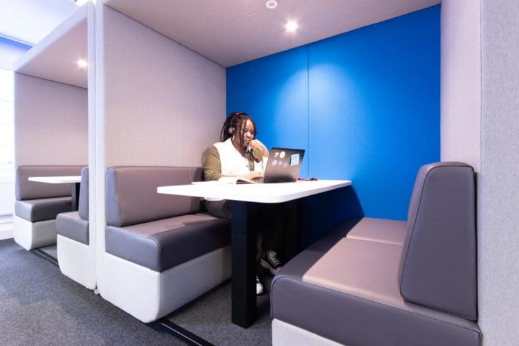 Office worker in an acoustic pod