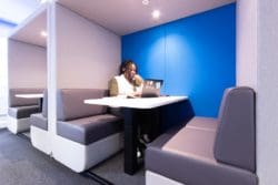 Office worker in an acoustic pod
