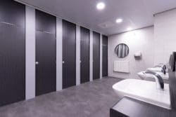School toilet cubicles with downlights and motion sensor taps