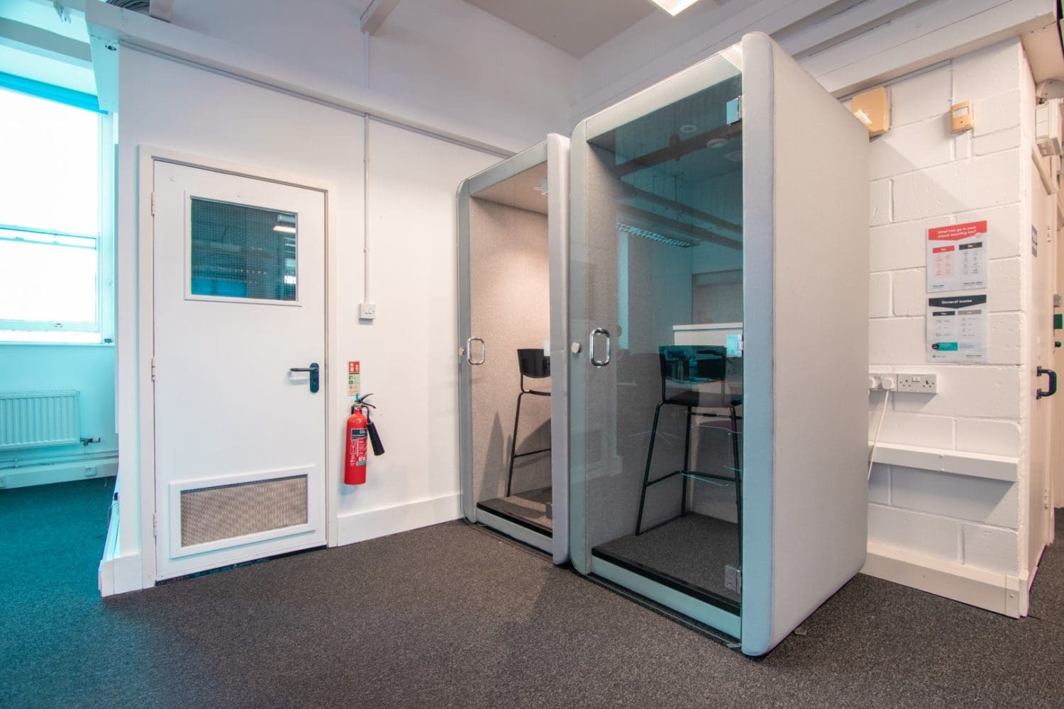 Soundproof office booths with glass doors in a London office space