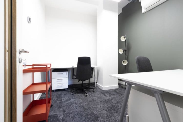 Soundproof office room with desks and new carpet