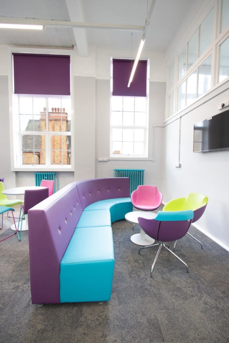 School staff room with modular sofa and TV