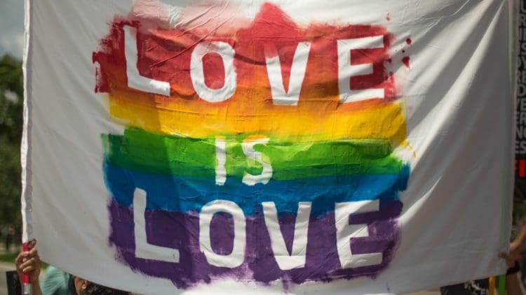 Gay Pride flag with love is love written on it