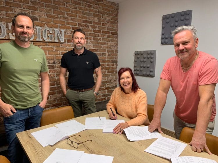 Rap Interiors directors signing paperwork for company takeover