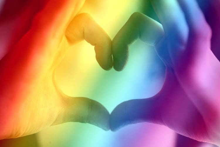 Two hands making heart shape for a pro Gay Pride message
