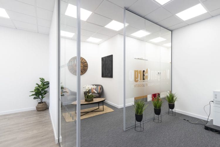 Glass office partitions with company logo for a corporate office design