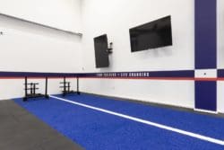 Gym interiors with inspirational quotes and a sled track