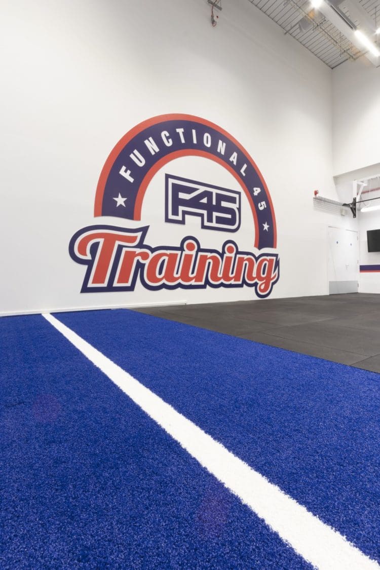 Gym sled track and wall feature at F45 London