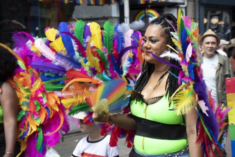 Lady with rainbow feather costume at Pride Canterbury 2022