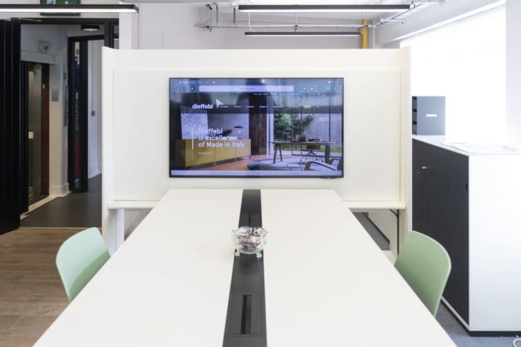 Office collaboration area with monitor for group work