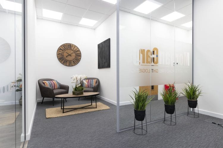 Office waiting area interior design with soft seating and a coffee table