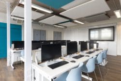 ICT classroom design with retractable desks and a storage wall